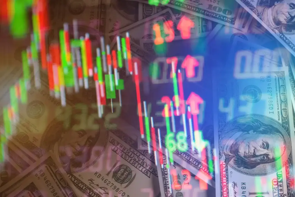 Imagem de gráficos financeiros coloridos sobrepostas a notas de cem dólares, representando o mercado financeiro, ações e investimentos.