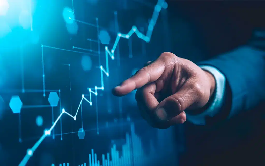 Pessoa tocando uma tela digital com gráficos e linhas de crescimento, simbolizando análise de dados, negócios e tecnologia.