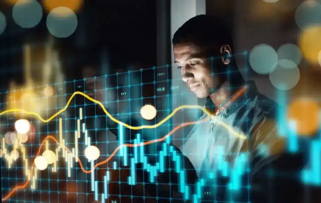 Homem analisando gráficos financeiros digitais com luzes coloridas e tecnologia avançada, representando análise de dados ou investimentos no mercado financeiro.