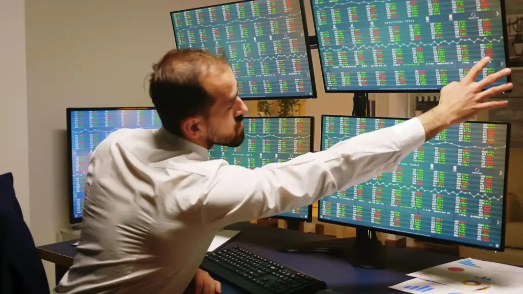 Homem analisando gráficos financeiros digitais com luzes coloridas e tecnologia avançada, representando análise de dados ou investimentos no mercado financeiro.